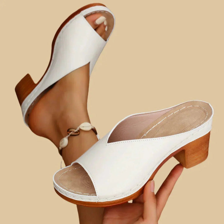 Comfortable women's open-toe sandals with a supportive block heel, perfect orthopedic footwear for summer fashion.