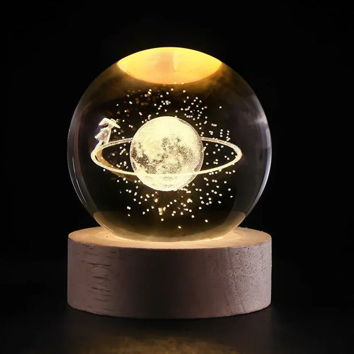 Glowing crystal ball galaxy lamp with a detailed 3D universe, supported by a stylish wooden base. LED light.