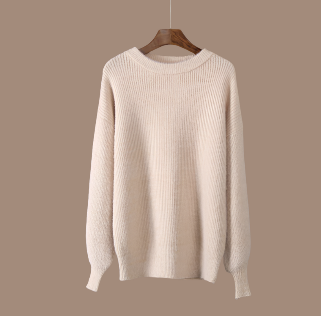Elegant beige women's knit jumper, perfect for cozy winter wear. Stylish long-sleeve sweater with a relaxed fit.