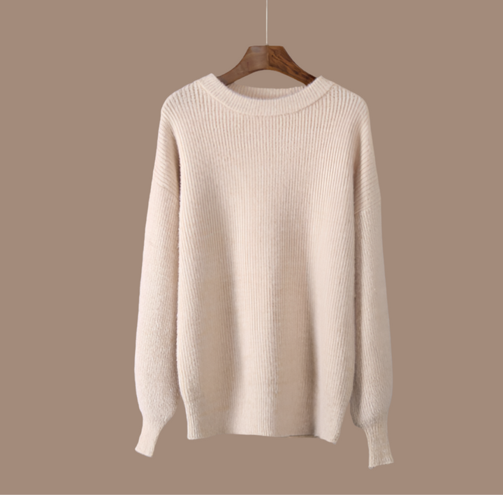 Elegant beige women's knit jumper, perfect for cozy winter wear. Stylish long-sleeve sweater with a relaxed fit.