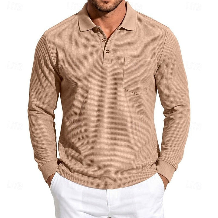 Detail shot of a men's textured long-sleeve polo shirt. Showcases fabric for refined casual & smart style.
