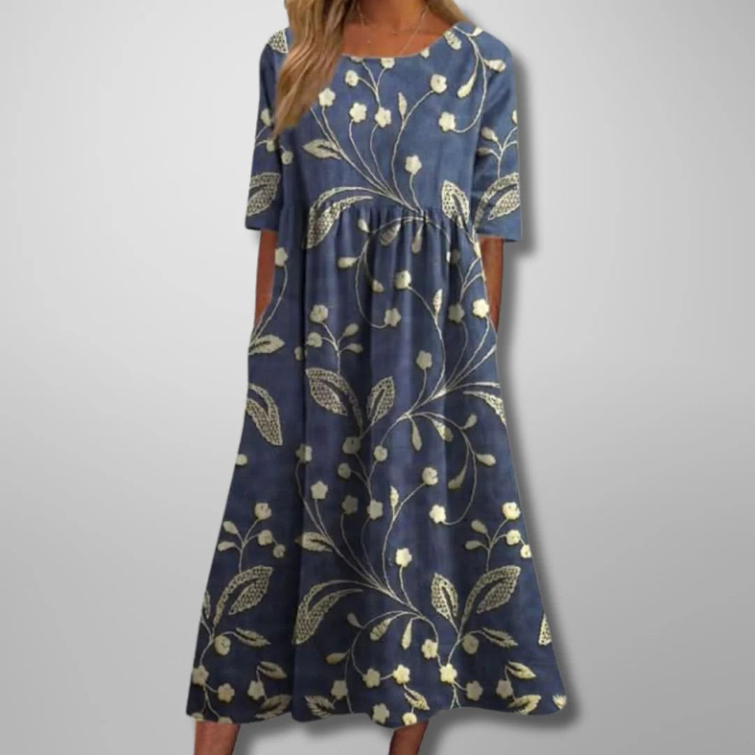 Women's relaxed floral midi dress in navy blue. Flowing design, perfect for effortless spring & summer casual style.
