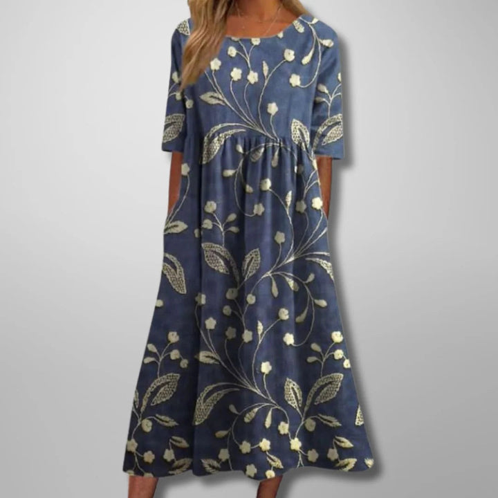 Women's relaxed floral midi dress in navy blue. Flowing design, perfect for effortless spring & summer casual style.