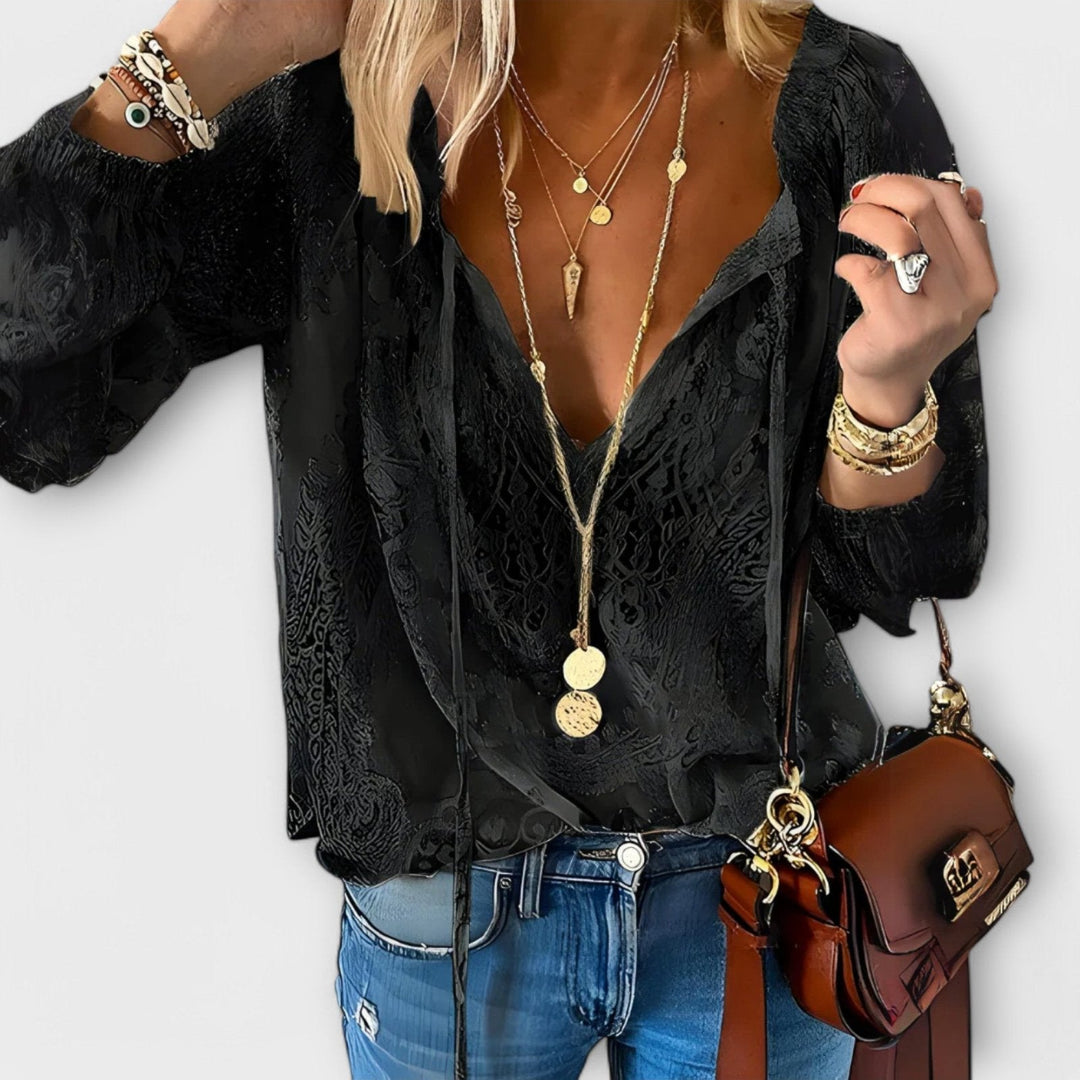 White women's tie-neck blouse with draped fabric, ideal for versatile office wear or chic everyday style.