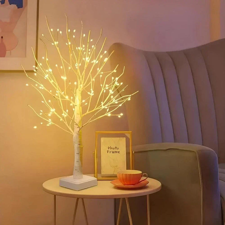 Artistic LED bonsai birch tree lamp, emitting warm white light; a chic decorative piece for home or office.
