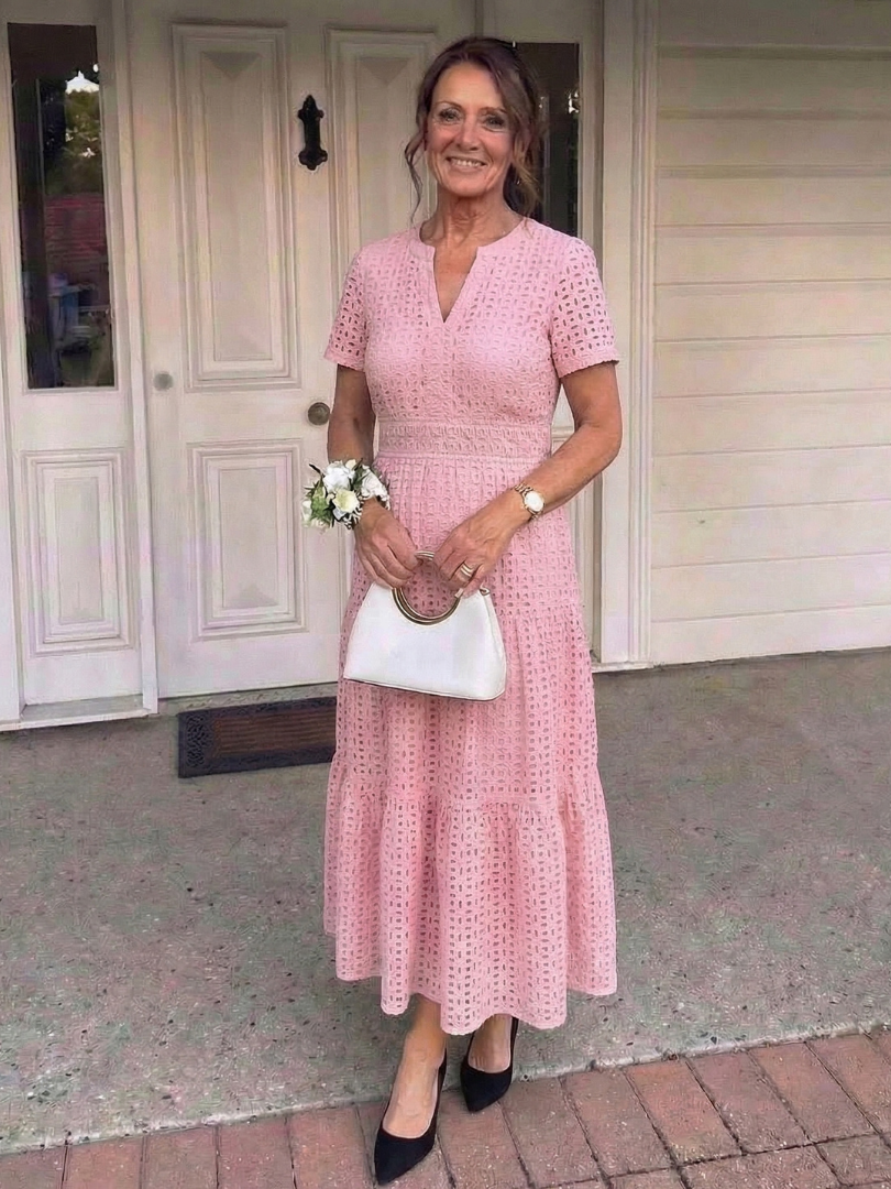 Elegant women's tiered midi dress with eyelet fabric and short sleeves, ideal for spring and summer events.