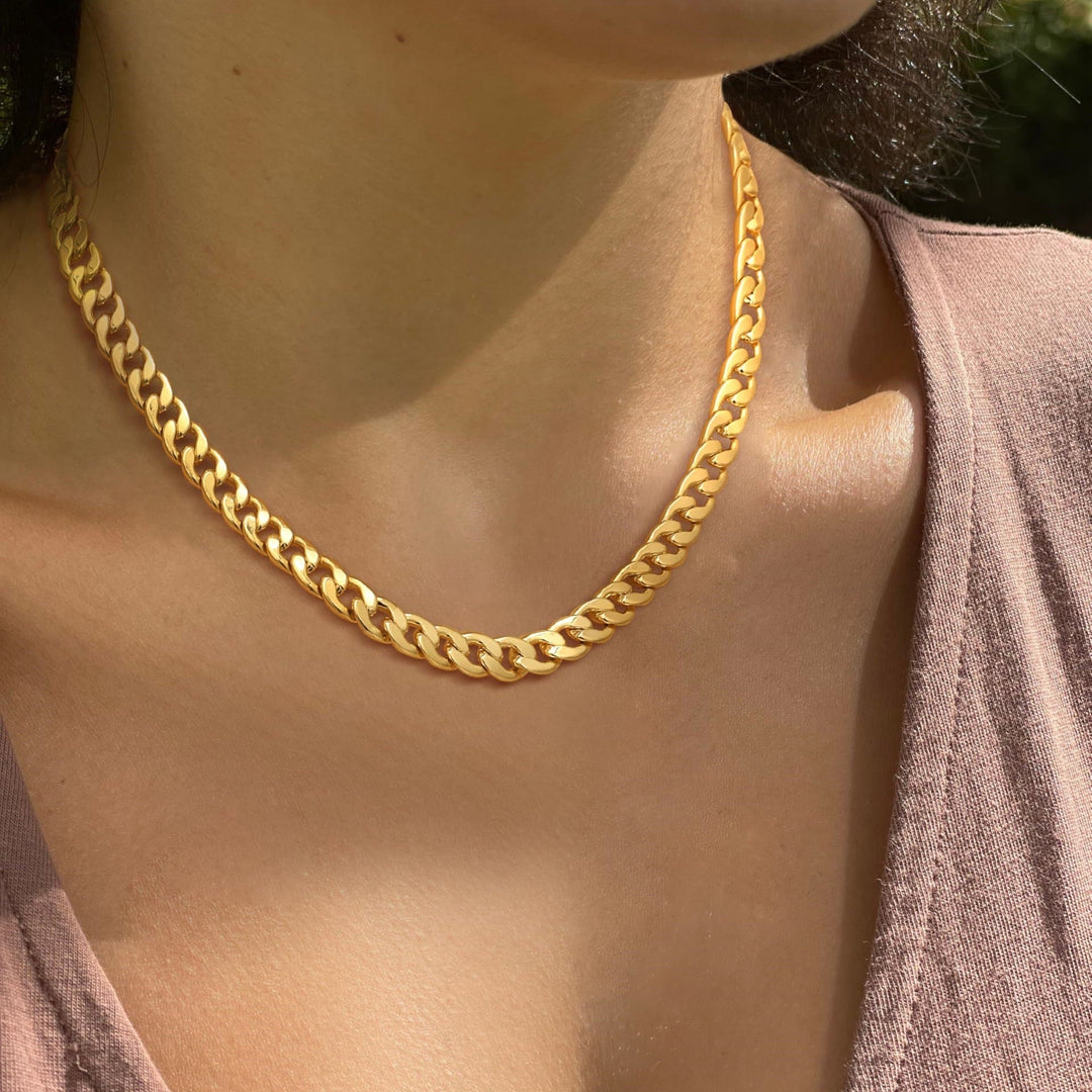 Unisex minimalist modern necklace and bracelet set in sleek gold-tone steel, perfect for everyday chic style.