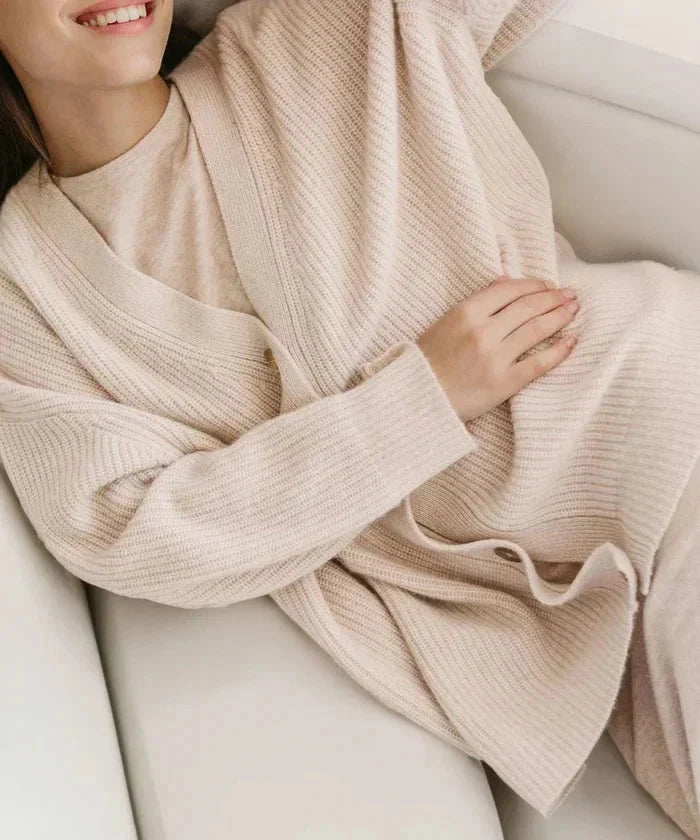 Beige cozy knit cardigan vest for women, modern relaxed fit, perfect for elegant layering.