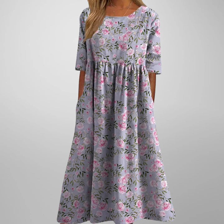 Women's relaxed fit midi dress. Navy blue floral pattern. Effortless style for spring, summer & casual wear.
