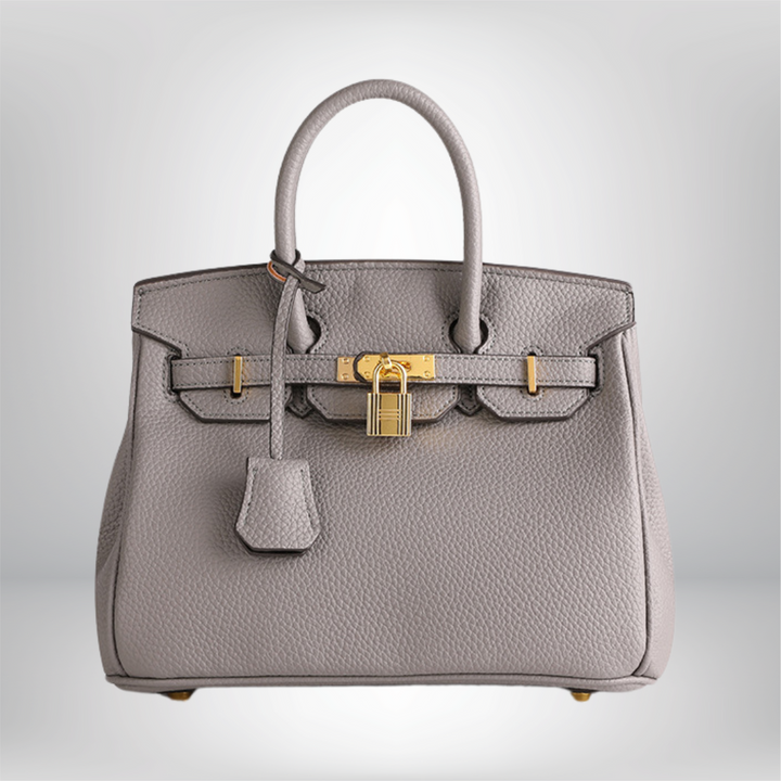Premium women's handbag: embossed leather texture and exquisite gold embellishments.