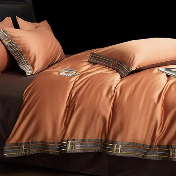 Inviting bed styled with a luxurious unisex embroidered cotton bedding set, perfect for restful sleep.