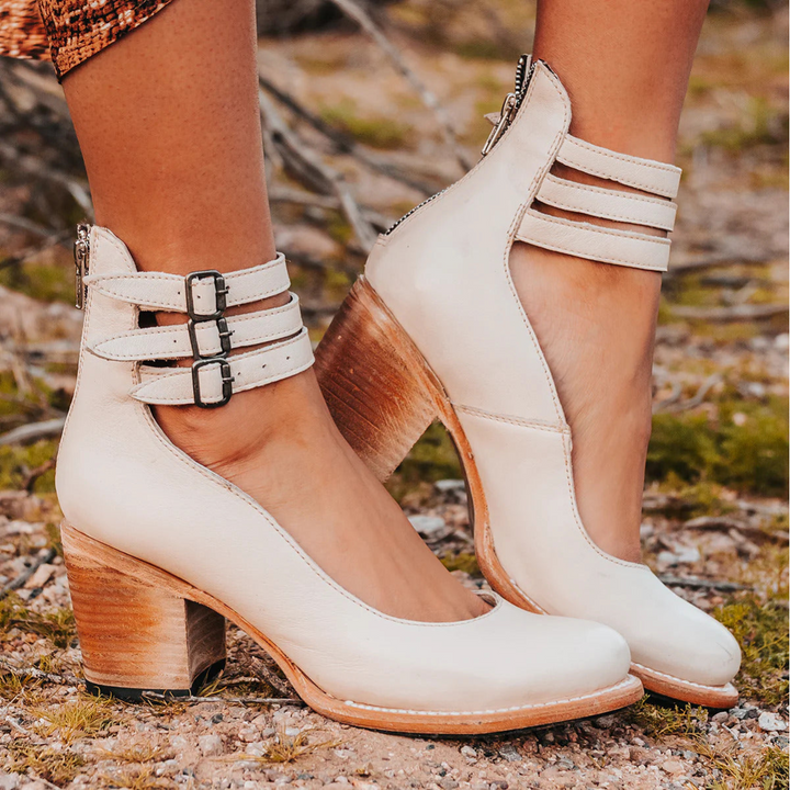 Orthopedic women's ankle boots featuring stylish strappy design, buckles, and a comfortable block heel.