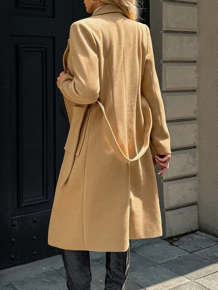 Close-up of the sophisticated belt on a women's long tailored trench coat. Elegant and versatile.