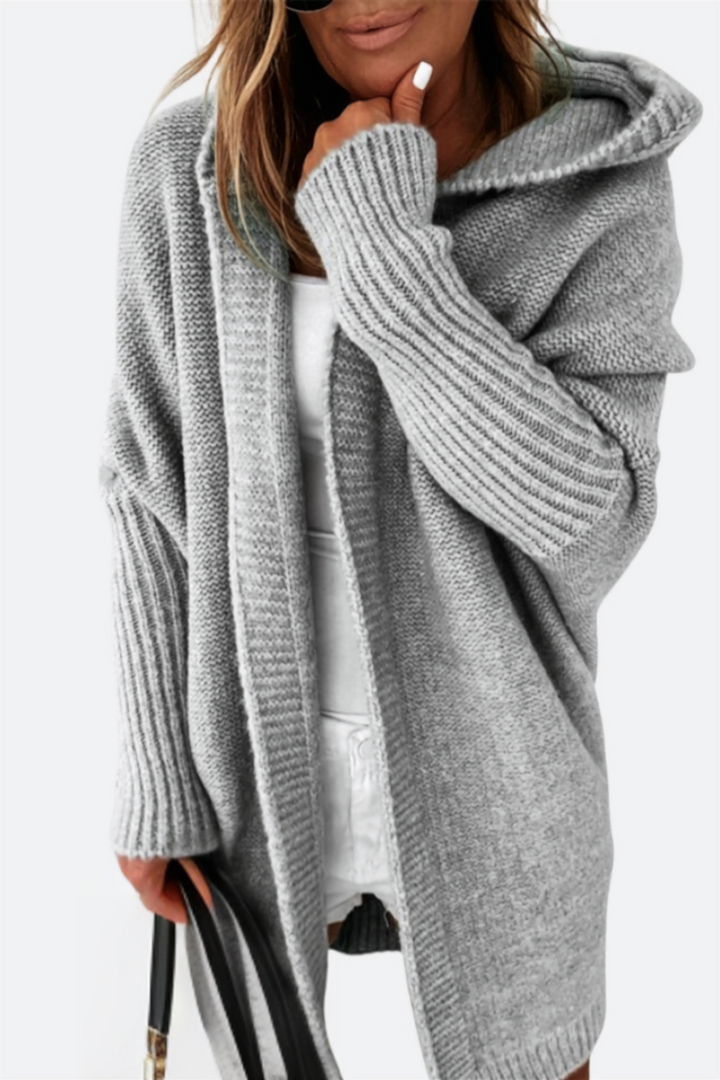 Women's warm oversized hooded knit cardigan, essential for cozy autumn and winter fashion.