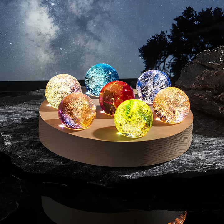 Decorative galaxy orb with crystal effect and illuminated wooden LED base, ideal for ambient lighting.