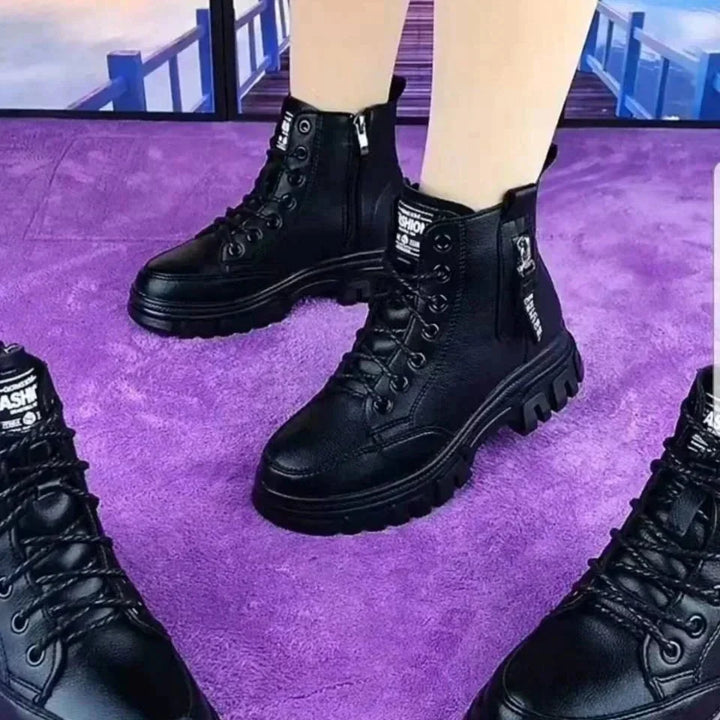 Stylish women's black leather high-top combat boots featuring a convenient side zipper and lace-up front.