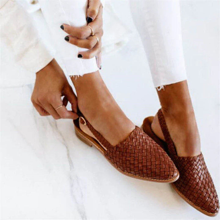 Elegant women's woven summer sandals, perfect for casual wear or beach outings. Flat, comfortable, open-toe slip-on design.