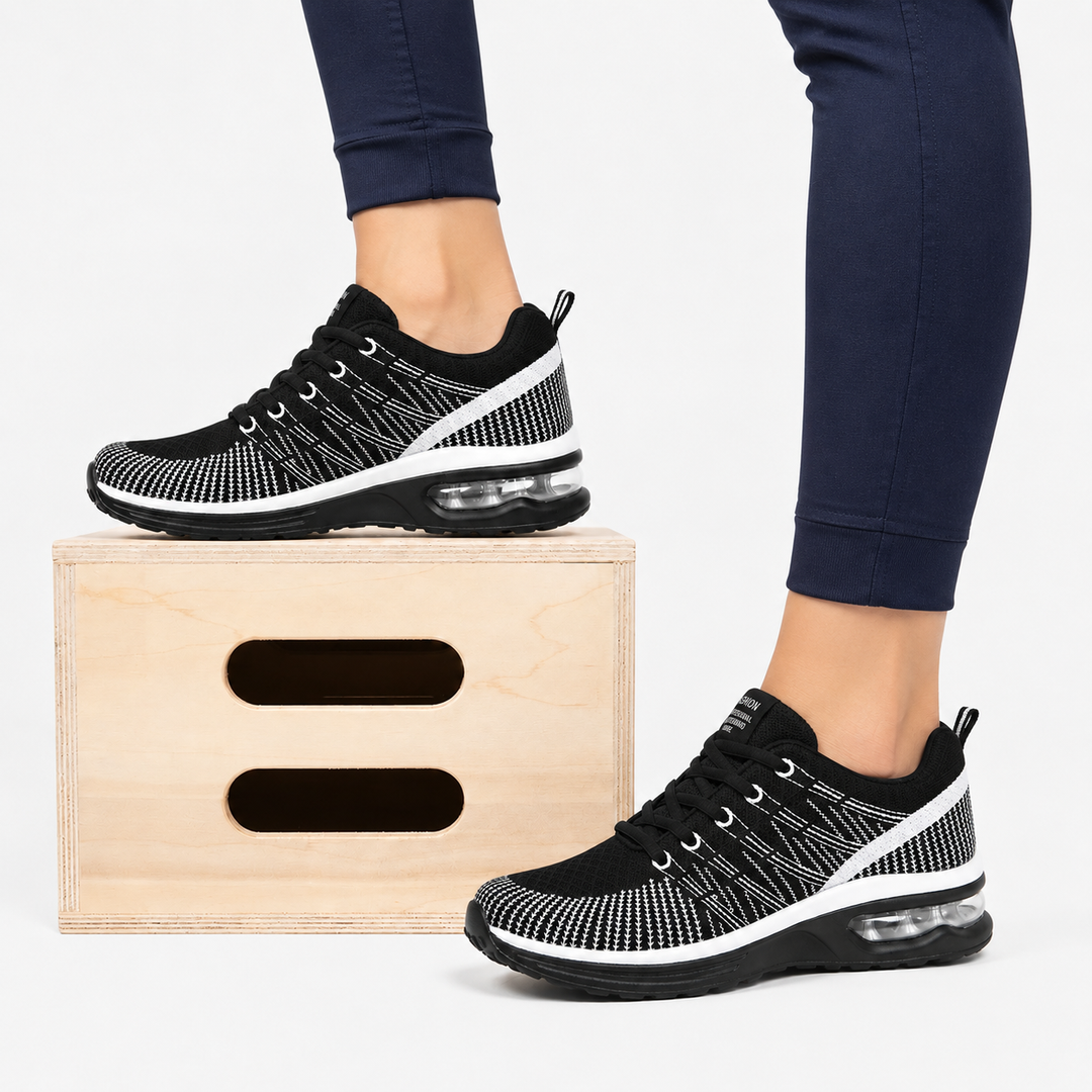 Sole view of women's supportive sneakers, showcasing slip-resistant air cushion technology.