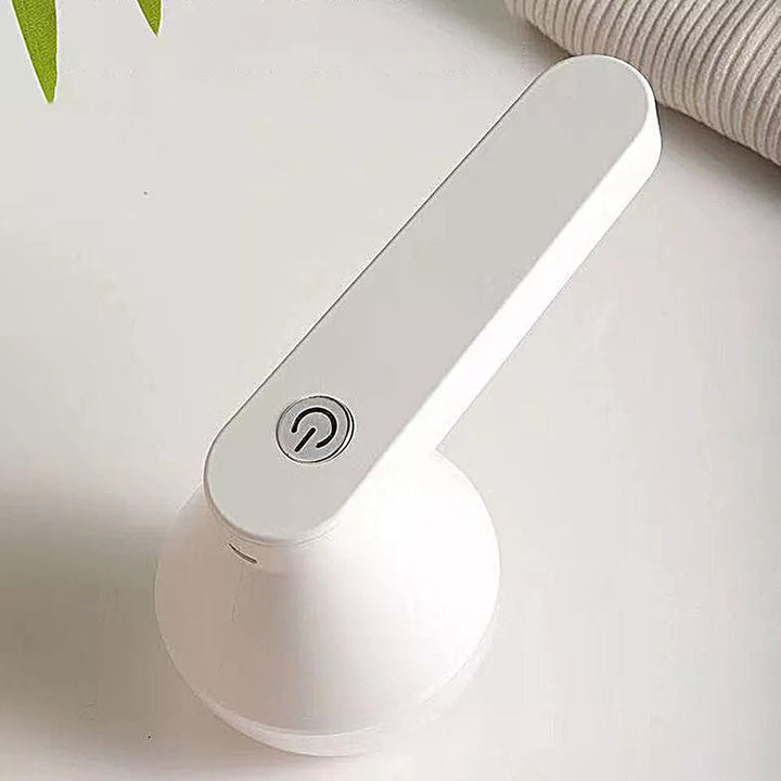 Compact cordless fabric shaver & lint remover for sweaters, upholstery. Portable garment care.