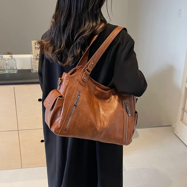 Durable faux leather shoulder duffle bag for women, organized and chic for work, travel, and daily use.