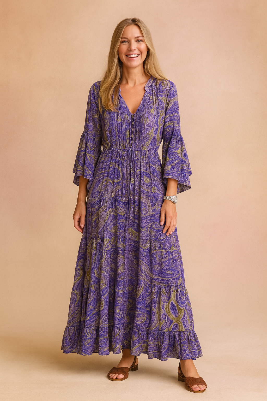 Bohemian women's maxi dress featuring a flowy tiered design, elegant V-neck, and long paisley flared sleeves.