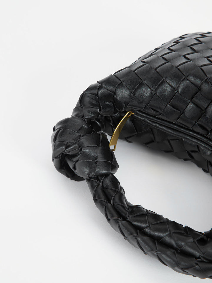 Fashionable women's shoulder bag showcasing a beautiful braided texture and chic knot handles.