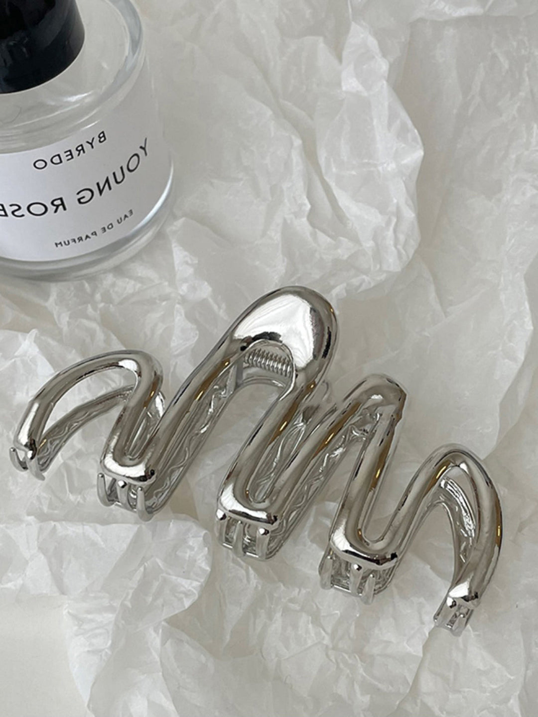 Silver metal Fluid Wave hair claw. Women's elegant hair accessory for updos & secure hair styling.