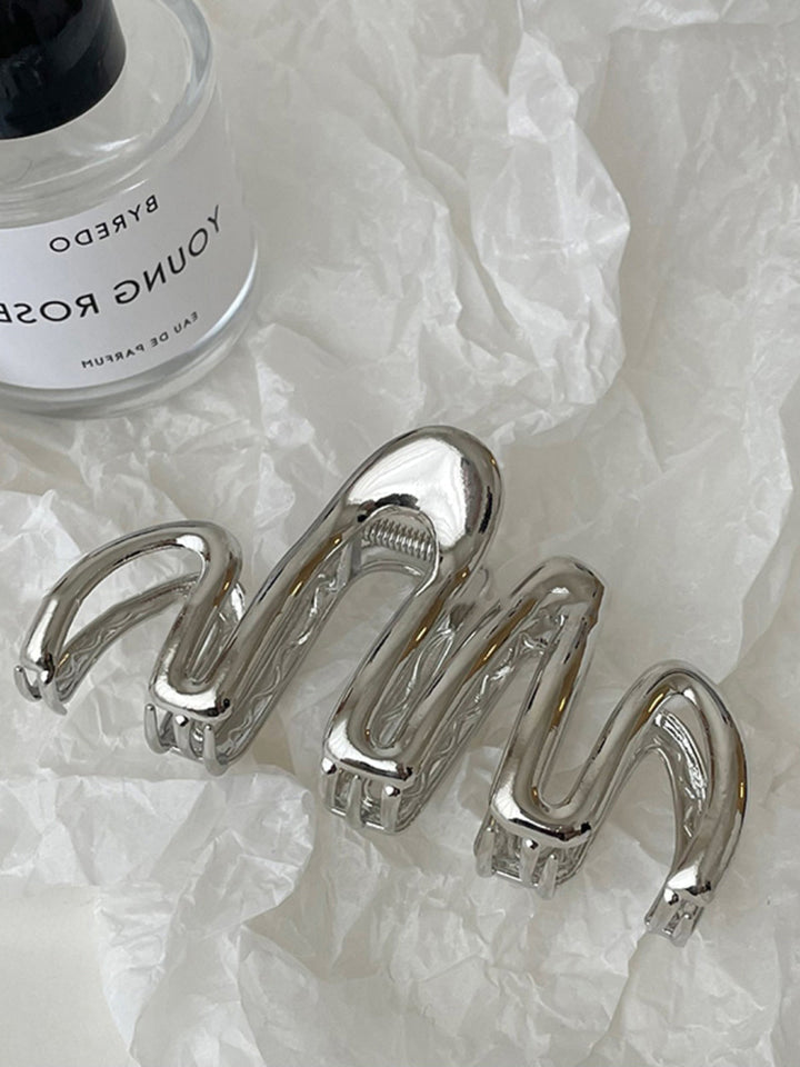 Silver metal Fluid Wave hair claw. Women's elegant hair accessory for updos & secure hair styling.