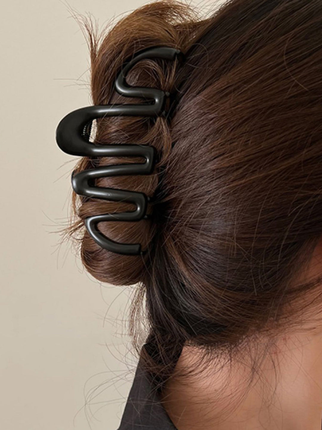 Black Fluid Wave hair claw, a chic women's hair accessory for elegant updos & versatile hair styling.