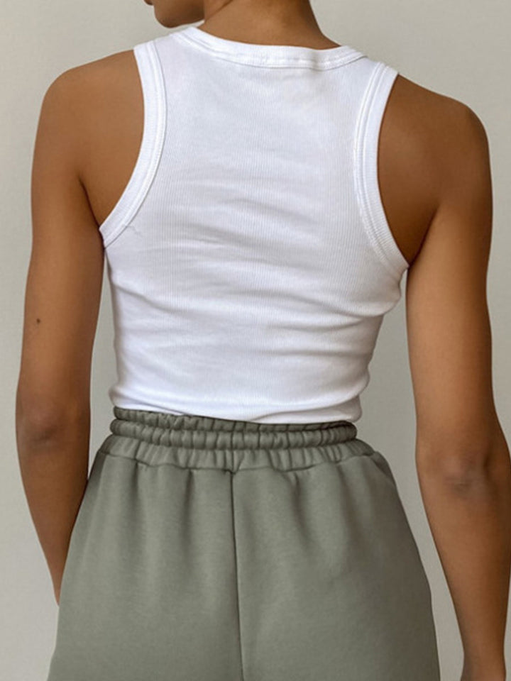 Sleeveless high-neck ribbed crop tank for women, ideal for modern layering or casual summer outfits.