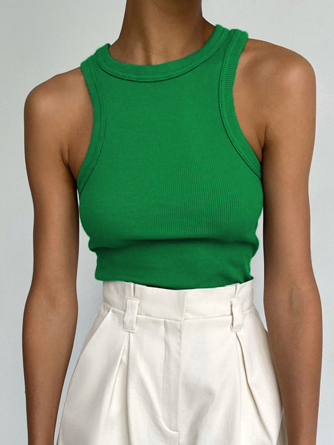 Women's summer fashion: fitted ribbed crop tank, sleeveless and high neck, ideal for chic layering.
