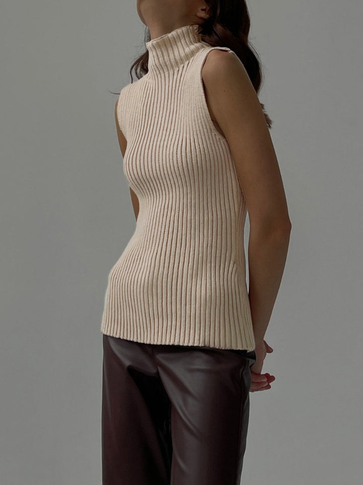 Versatile women's ribbed sleeveless top with a mock neck, a chic layering piece for year-round fashion. Modern silhouette.