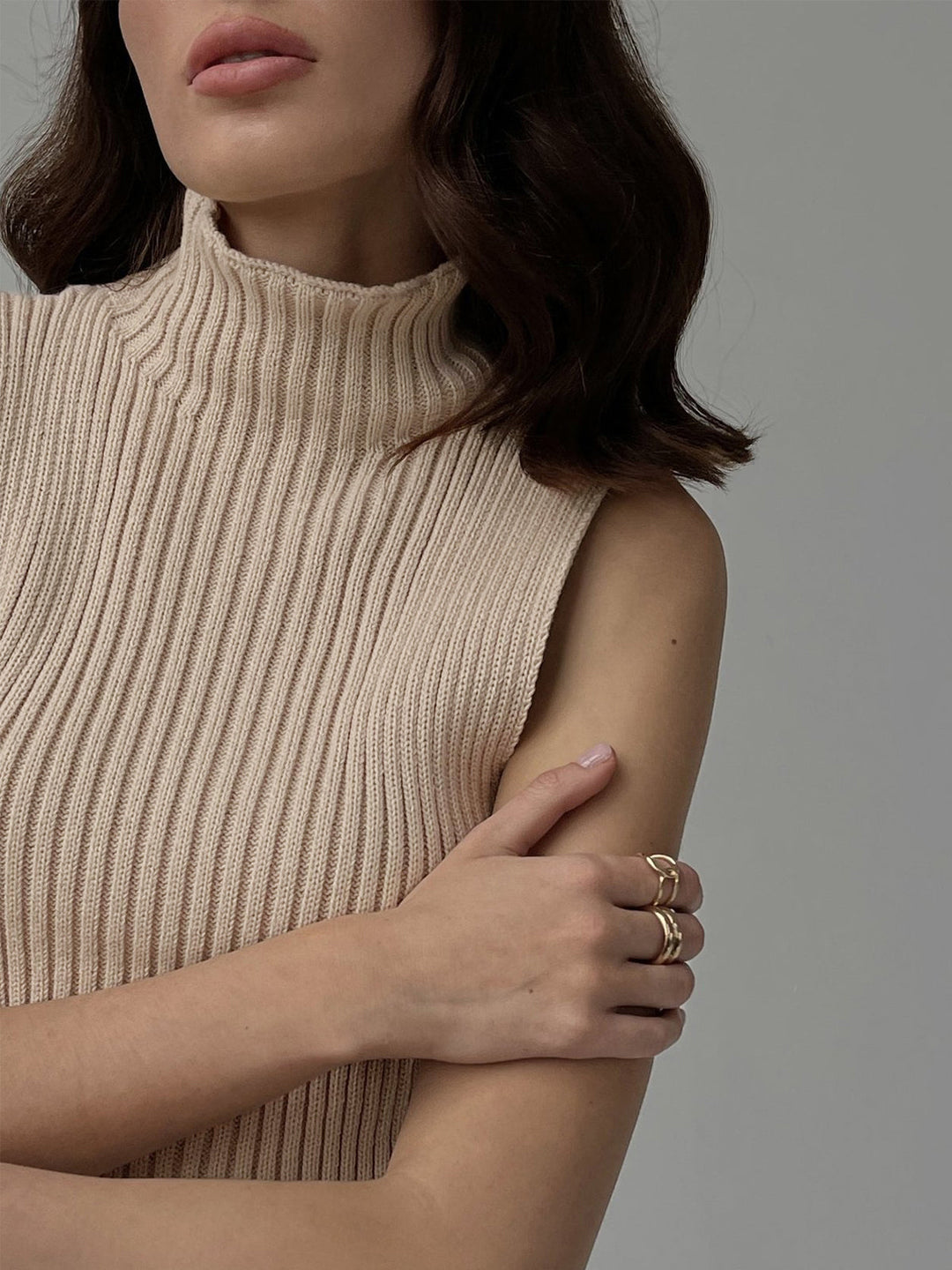 Casual chic women's sleeveless ribbed top with mock neck. A versatile modern silhouette for comfortable everyday wear.