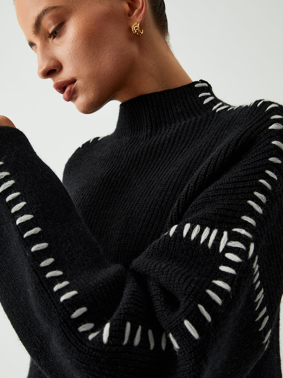 Effortlessly elegant women's oversized black mock neck sweater, offering cozy comfort and chic winter style.
