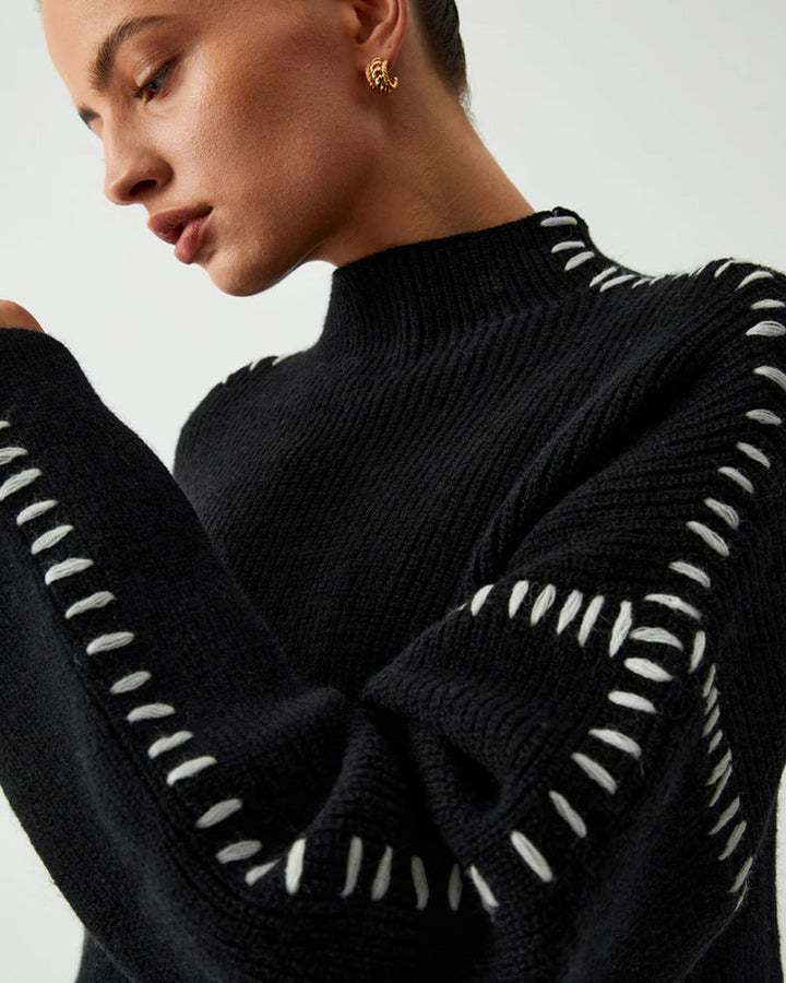 Stylish women's elegant oversized black sweater, a versatile long sleeve top for cozy winter wear.