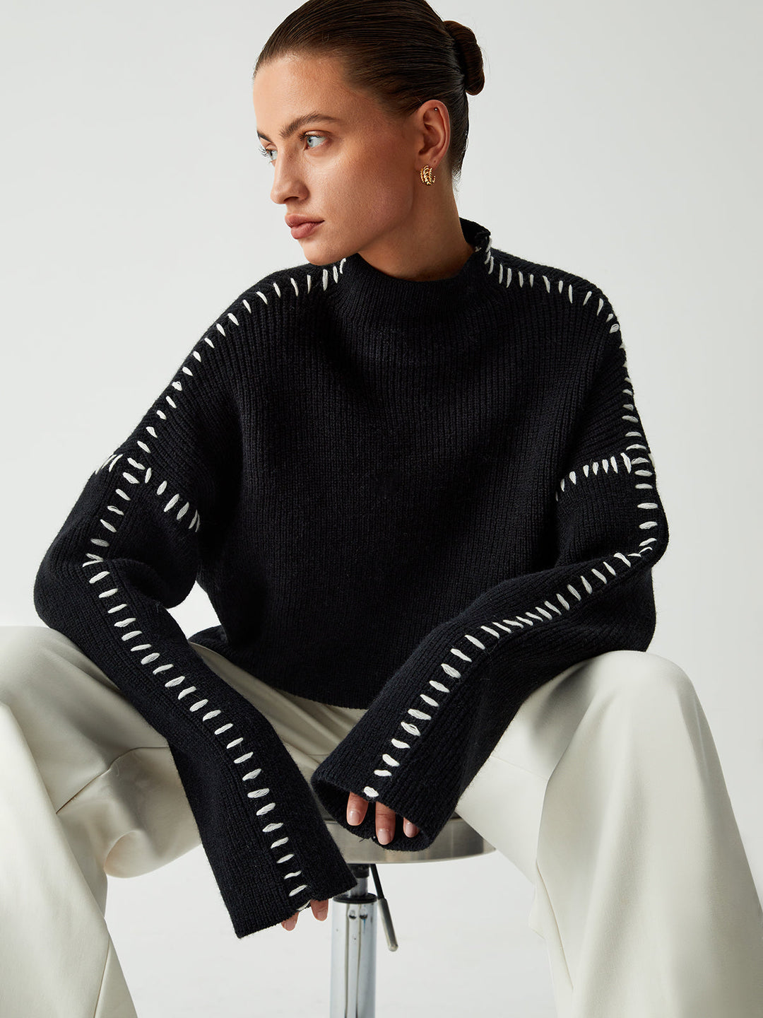 Statement chic oversized black women's mock neck sweater, versatile for warmth & sophisticated casual wear.