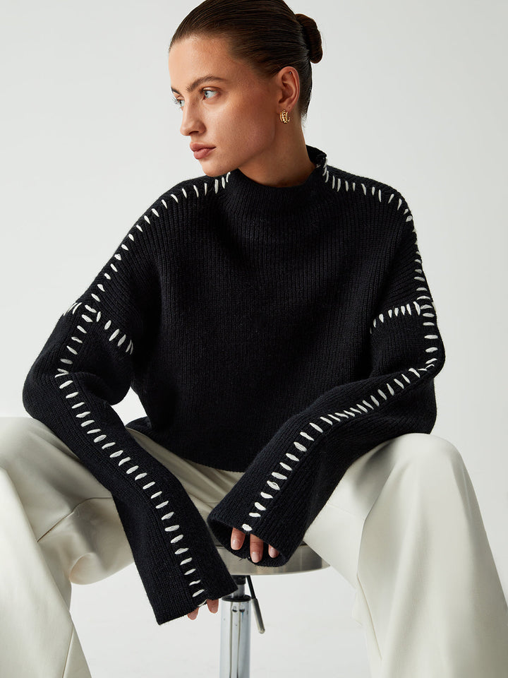 Statement chic oversized black women's mock neck sweater, versatile for warmth & sophisticated casual wear.