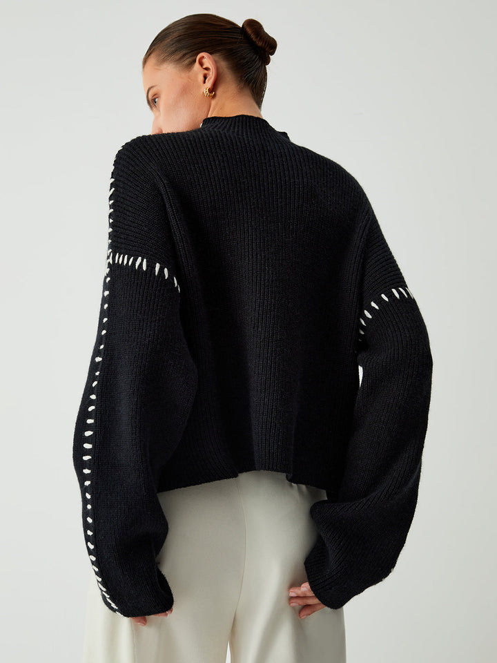 Black oversized women's mock neck sweater, a stylish and warm top for effortless elegance and comfort.