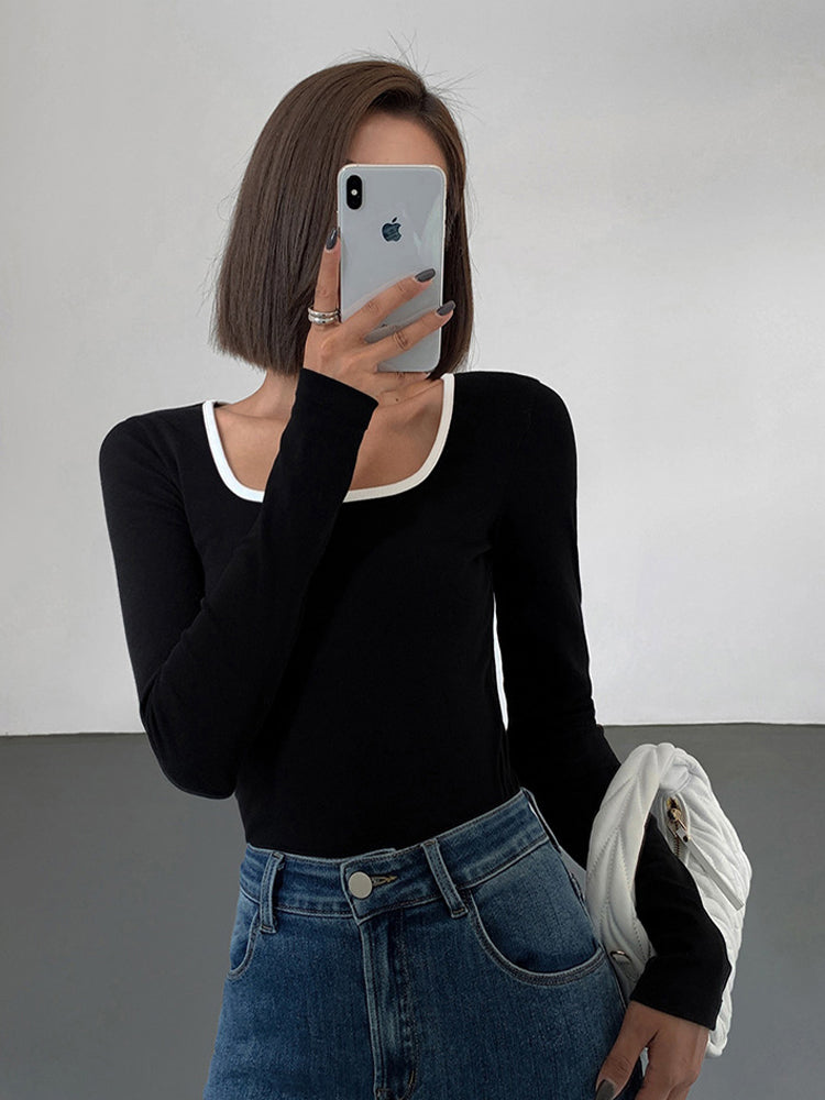 Stylish women's square neck top featuring elegant contrast trim. Modern short sleeve design for a chic look.