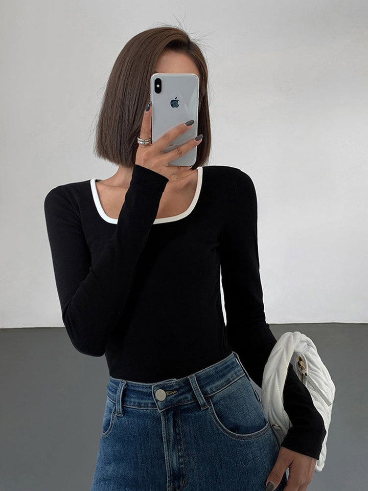 Stylish women's square neck top featuring elegant contrast trim. Modern short sleeve design for a chic look.