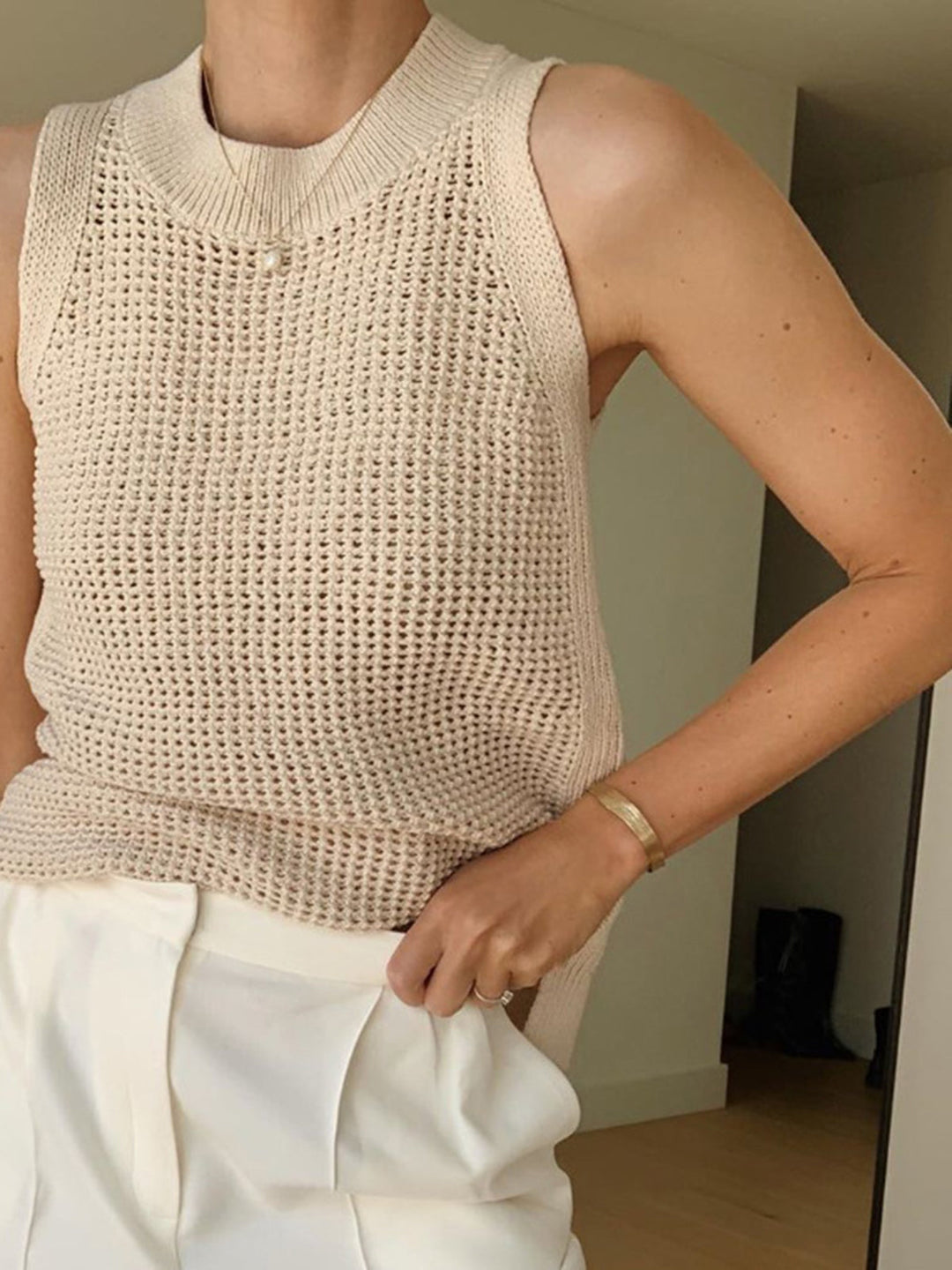 Soft knit women's sleeveless tank top with chic cut-out, comfortable for everyday wear & summer fashion.