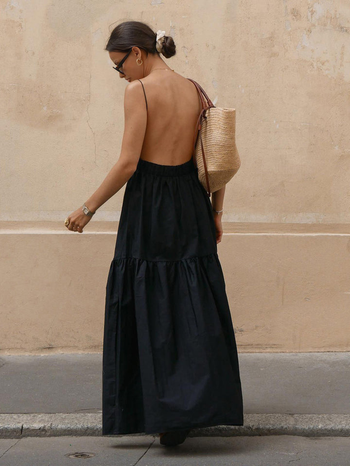 Graceful backless maxi dress in a flowing design, offering elegant summer vacation style.