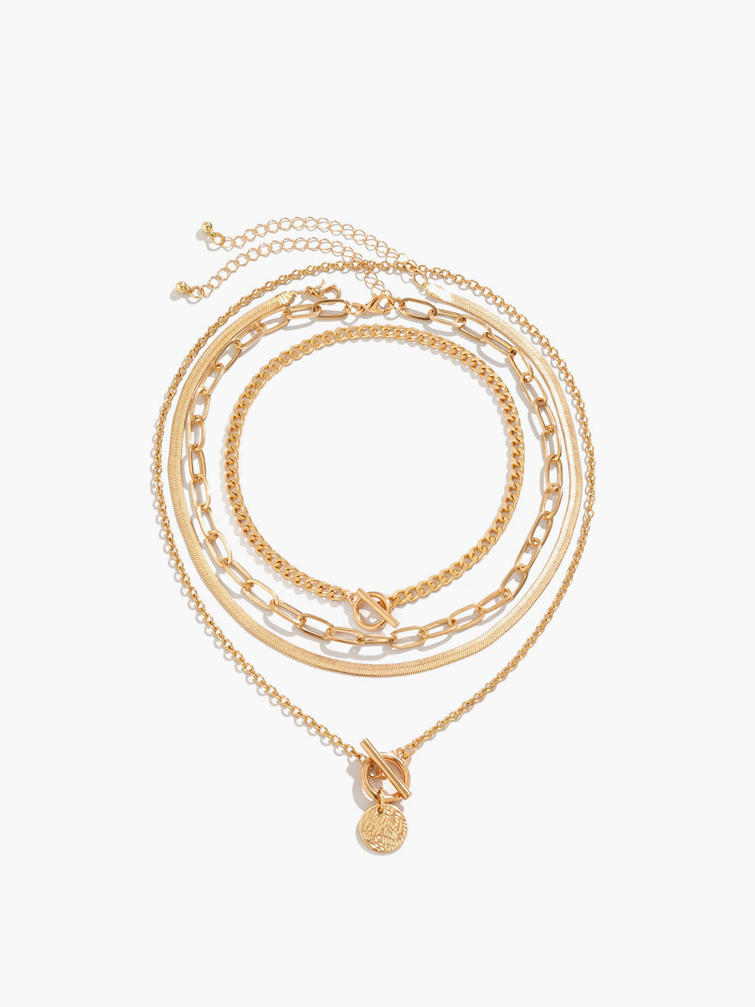 Close-up of a women's gold layered pendant necklace featuring multiple delicate chains & a detailed coin charm.