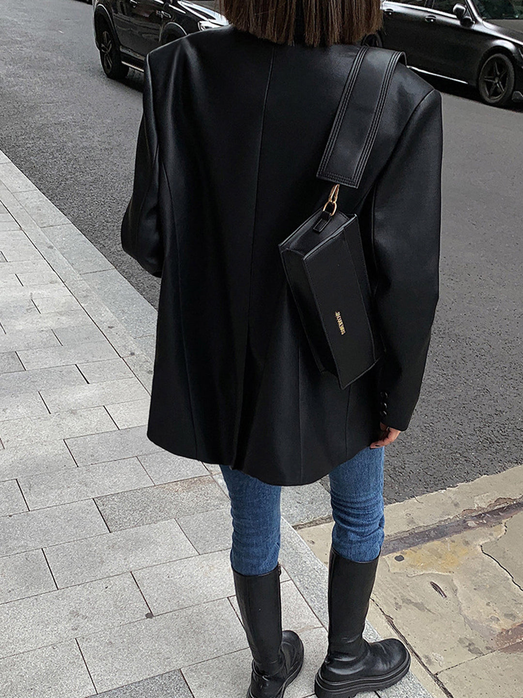 Black oversized women's blazer. Stylish statement jacket with lapel collar for chic layering & versatile fashion.
