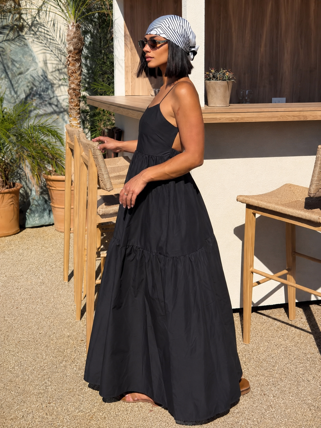 Sleeveless flowy summer maxi dress for women, featuring a sophisticated backless design.