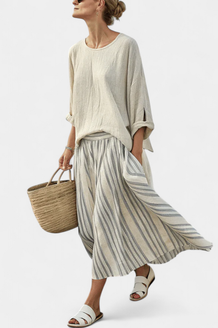 Elegant women's beige striped midi skirt & loose drop-sleeve blouse set. Perfect casual chic summer vacation outfit.