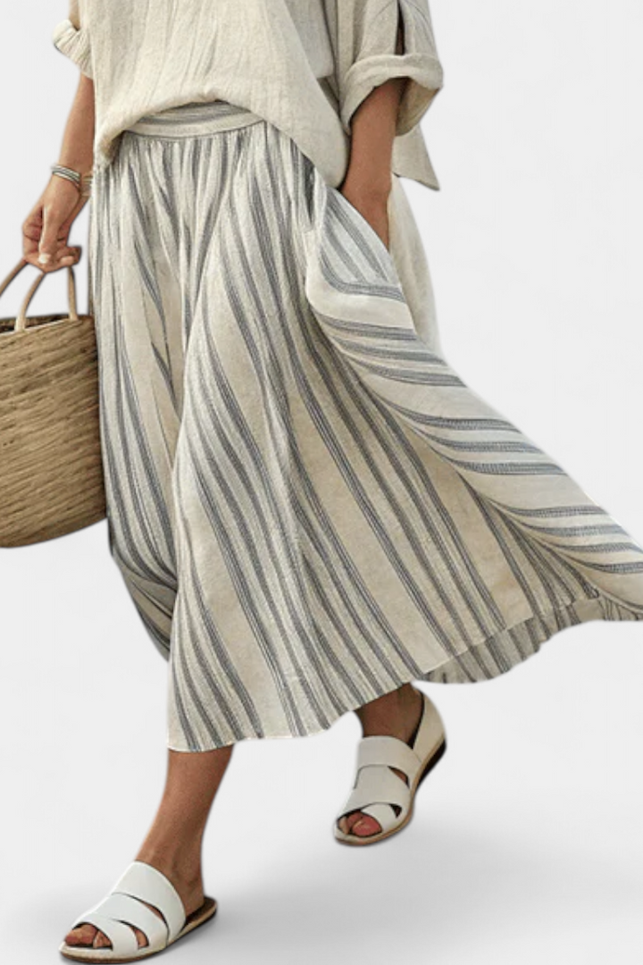 Women's casual chic striped midi skirt and loose blouse set in beige, ideal for summer fashion & vacation comfort.