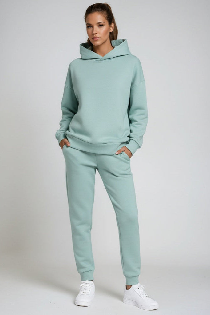 Soft women's hooded sweatshirt paired with comfortable elastic-waist joggers. Perfect cozy loungewear set.