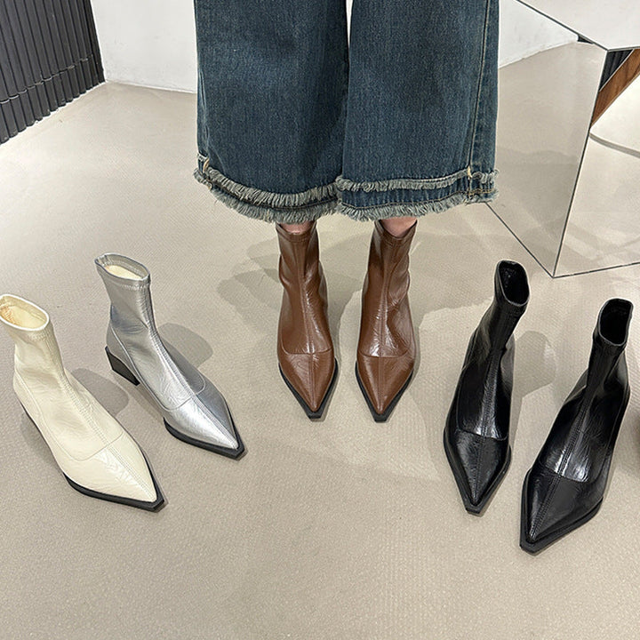 Elegant women's ankle boots featuring a sophisticated pointed toe and stable block heel.