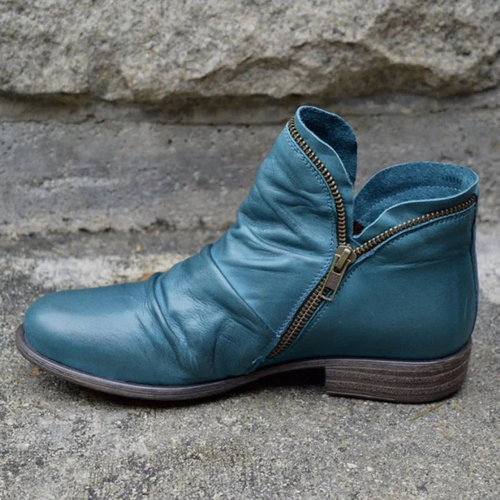 Elegant women's ankle boots with decorative ruffle detail and practical side zipper. Chic footwear.